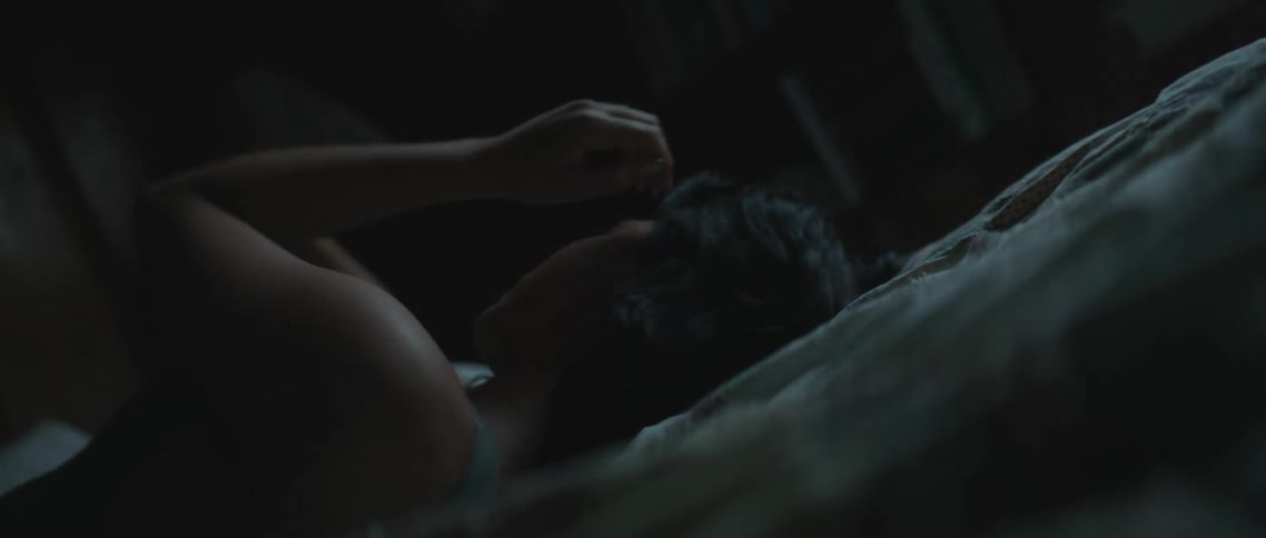 A woman sleeping in a bed