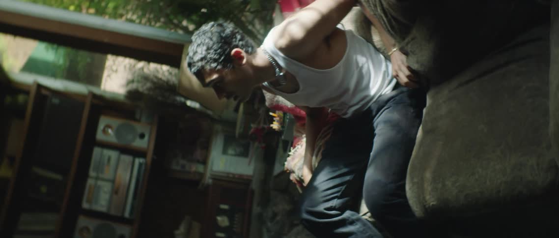 A man and woman fighting each other indoors