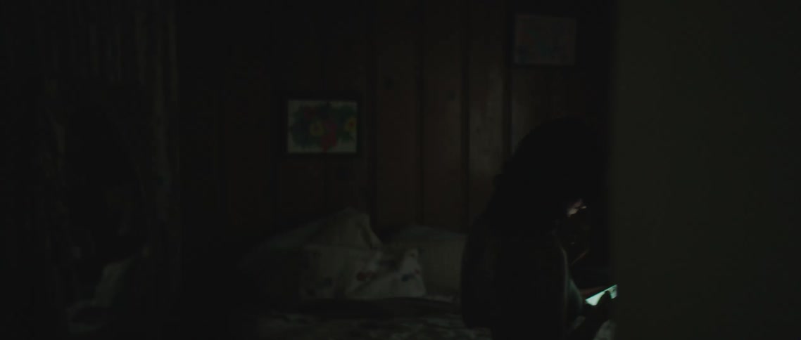 A woman pacing around a room on a phone