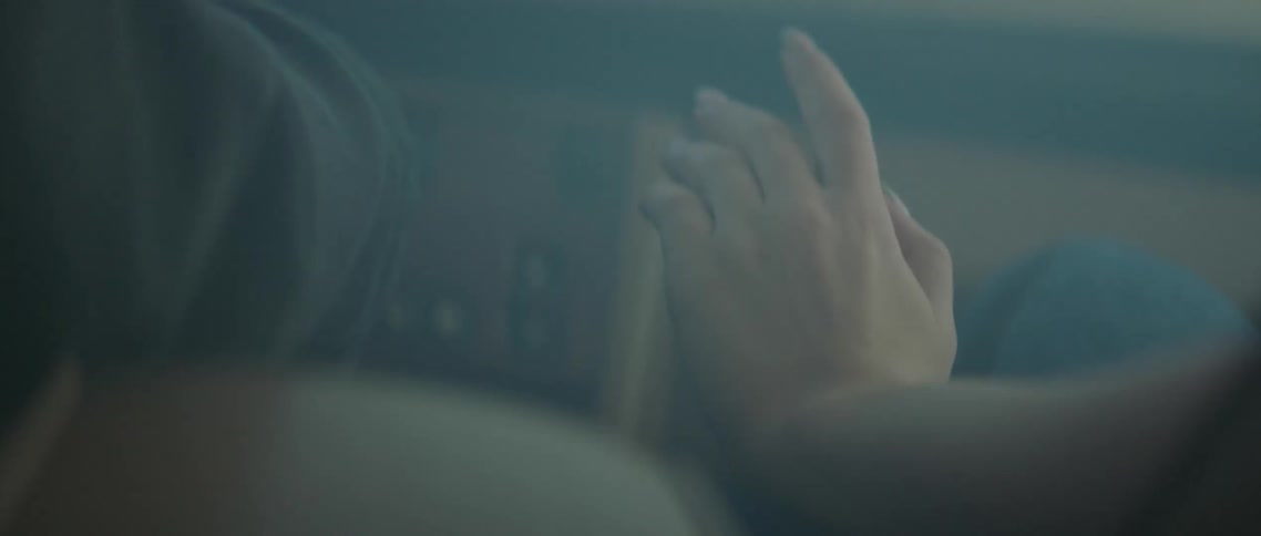 A view of an arm in the passenger seat of a car