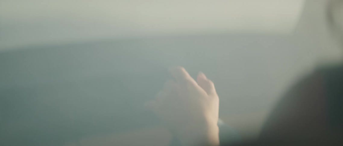 A girl sits in a smoky vehicle