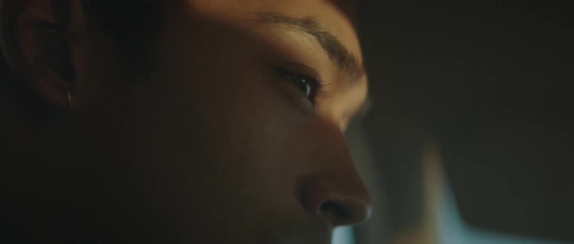 A man blinks as he drives a vehicle