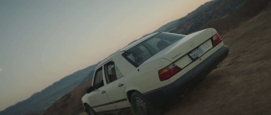 Twisting footage of a car parked on the hills at sunset