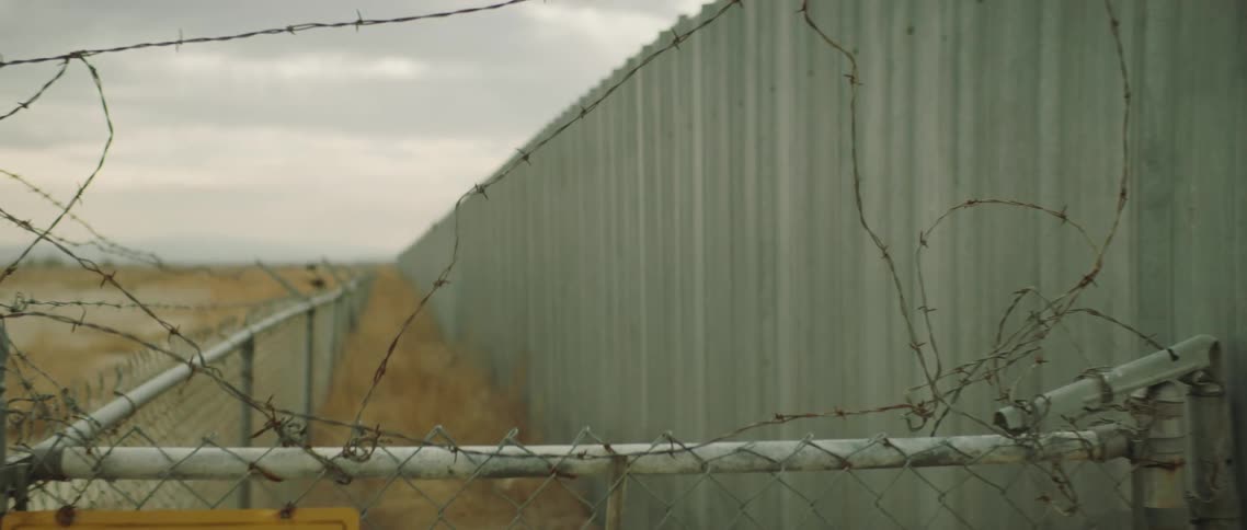 A view of a building and fence outdoors