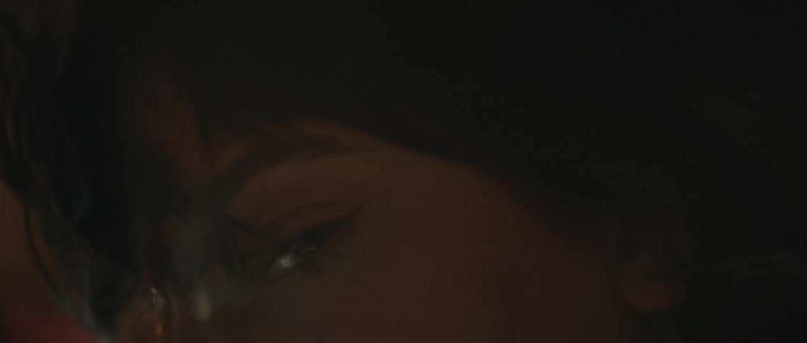 A woman is moving by the window in the moving vehicle