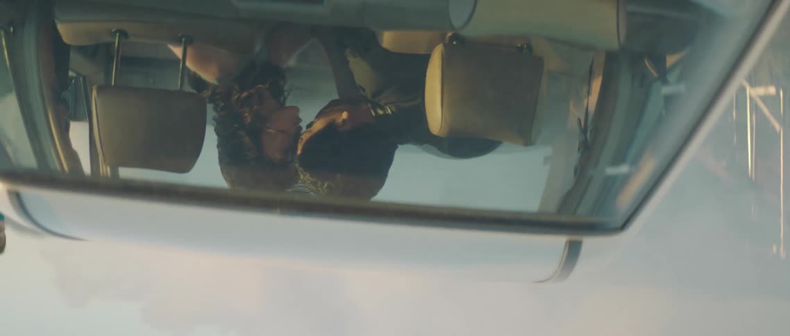 A couple are kissing in the car