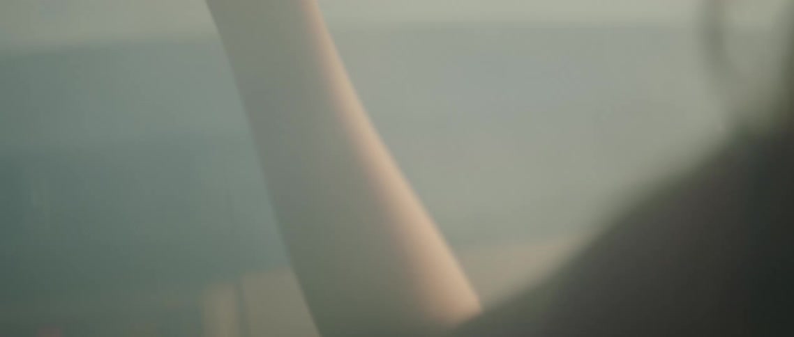 Woman sits in foggy hazy car reaching hand over divider toward drivers side