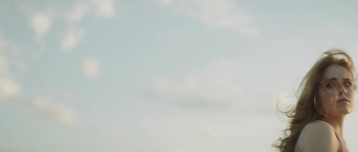 A man and woman standing and looking out into the distance