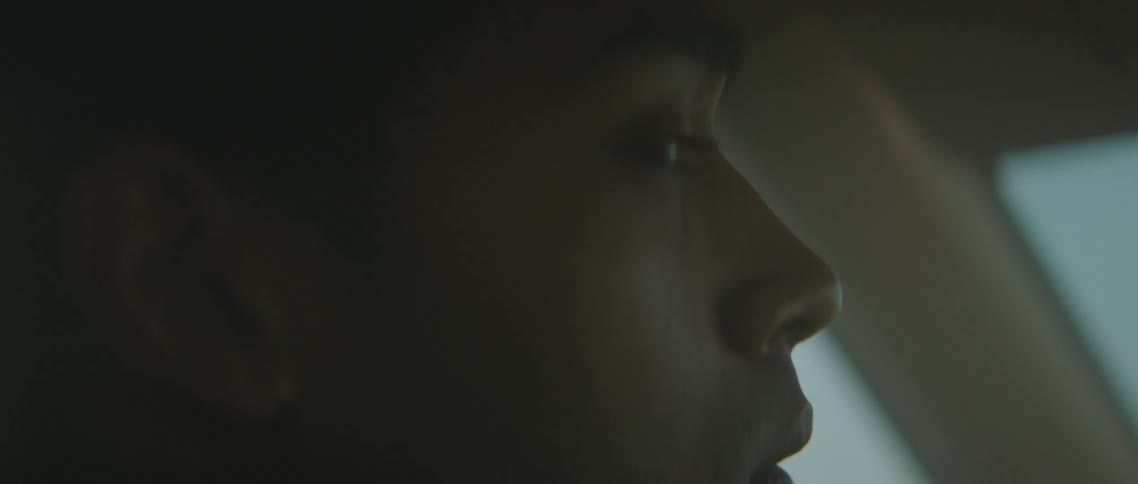 A man is looking to his side as he drives a car