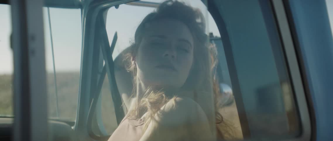 A woman riding in a truck down a road