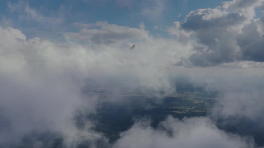 High above the ground in the sky a distant object falls rapidly towards the ground