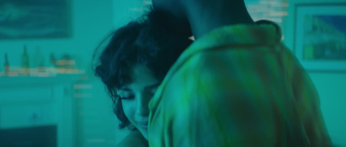 A couple dance at a party as the lights flash