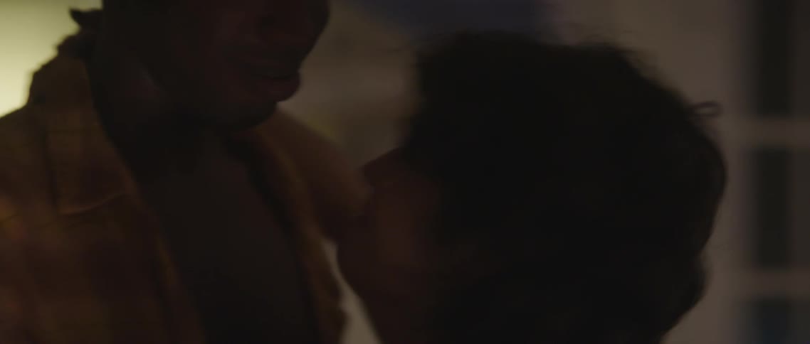 A man and woman are twirling around as they dance in the lights