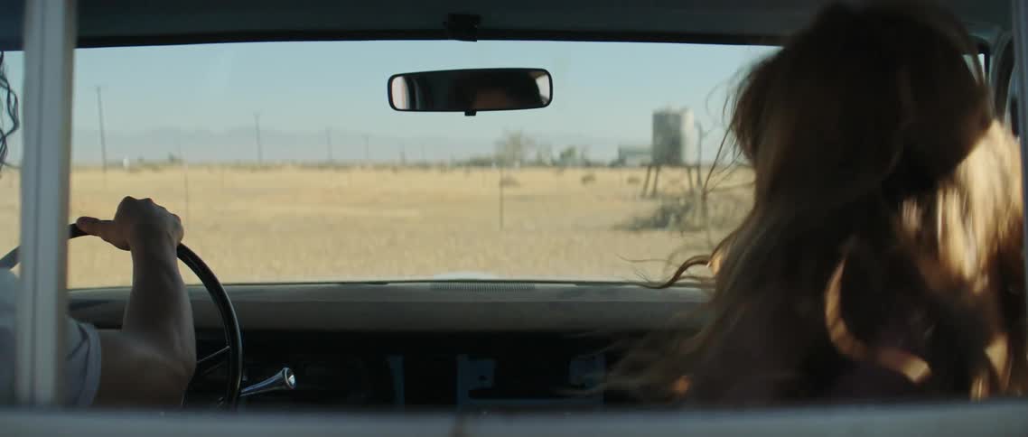 A woman running out of a house and into a truck