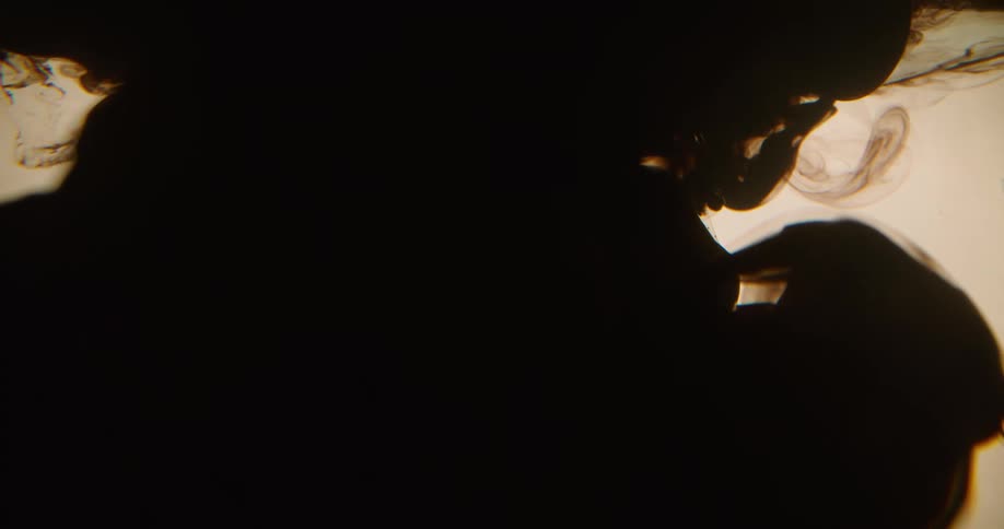 Abstract footage of dye going in to liquid