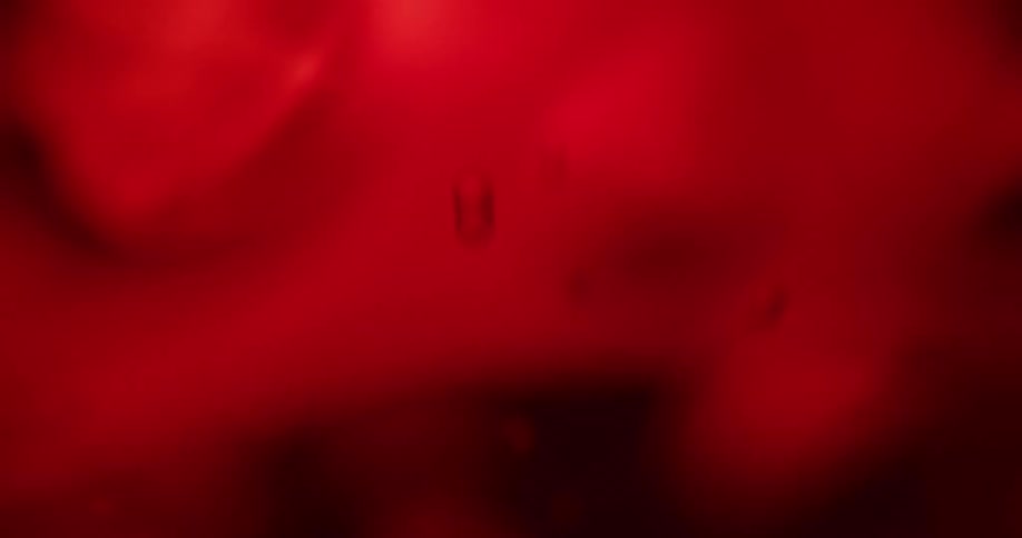 A close up of liquid with red glow