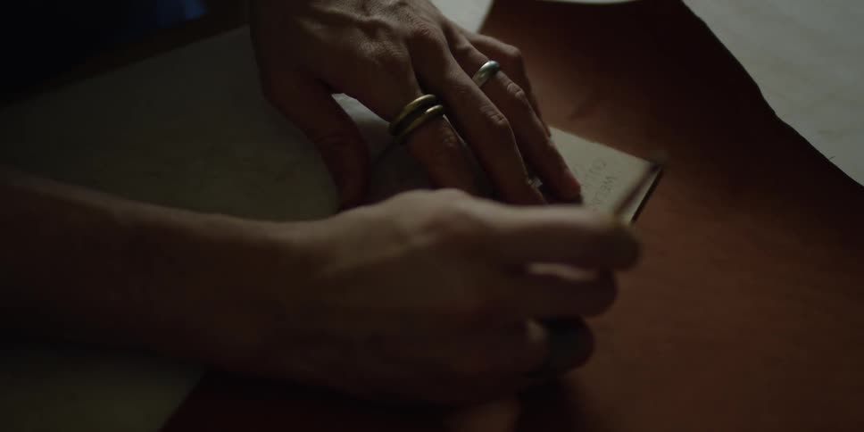 Someone tracing a stencil on a piece of leather