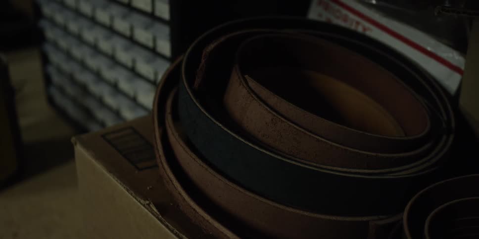 View of a stack of leather belts on a box
