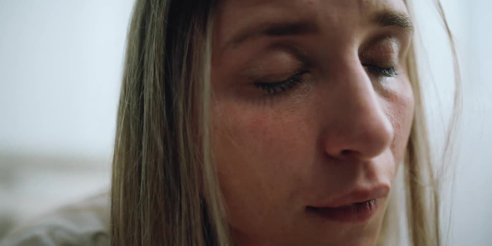 A woman in a room crying