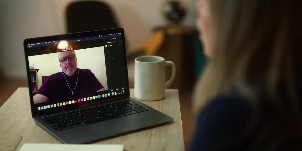 Young woman working at the office talking on a video call on a laptop
