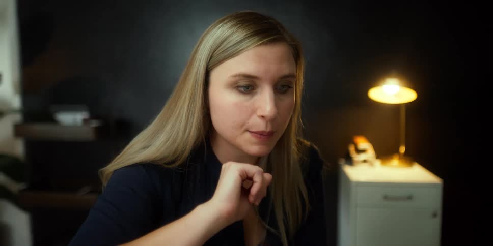 A woman talking while sitting in a room