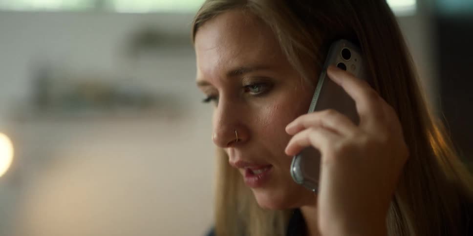 Determined blonde woman talking on the phone at the office