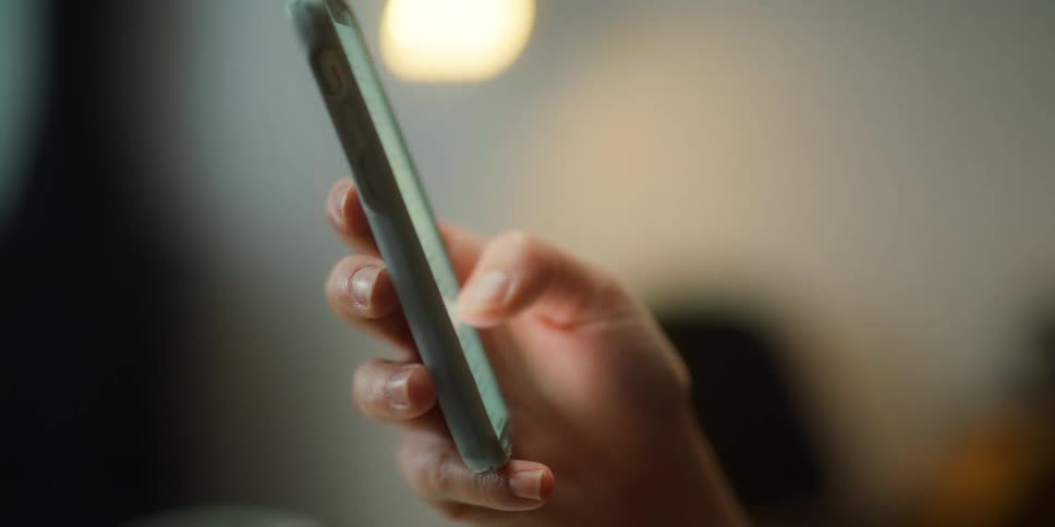 A close up of a hand using a phone