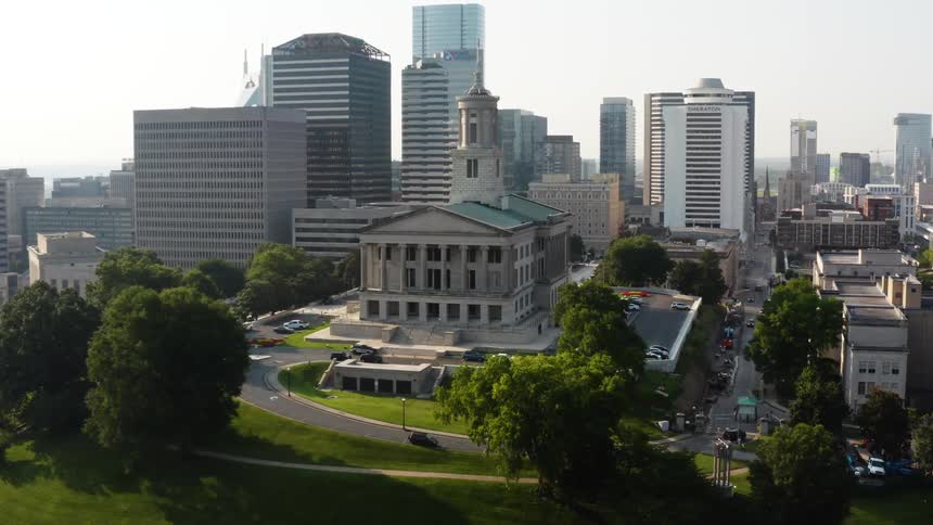 Aerial view of a classical building atop a hill in the city downtown at morning