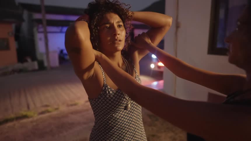 A woman stressed out outdoors near flashing lights