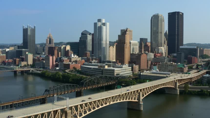 Aerial view of a downtown city is displayed during midday
