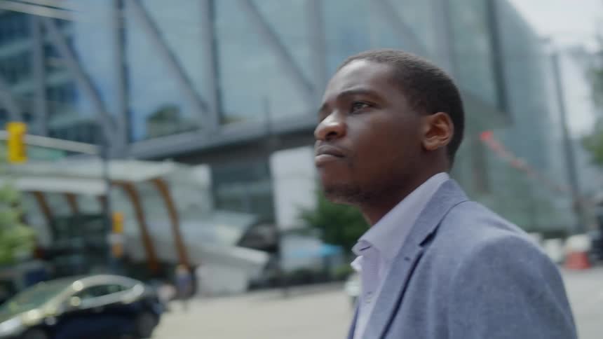 A man standing on the edge of a sidewalk