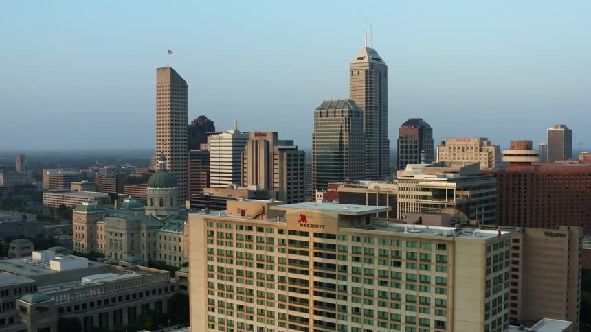 An aerial view of tall skyscrapers and buildings in a city in the daytime