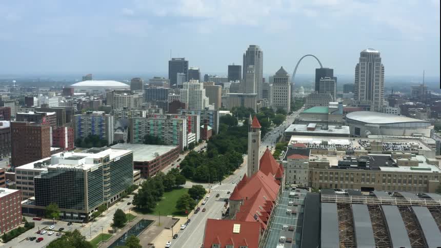 An aerial view of buildings and skyscrapers in a large city in the daytime