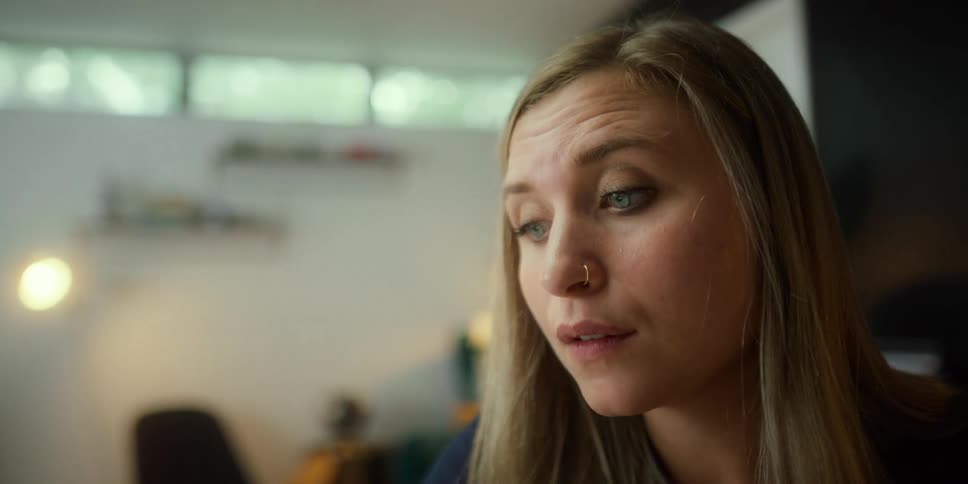 A woman looks upset as she speaks to someone