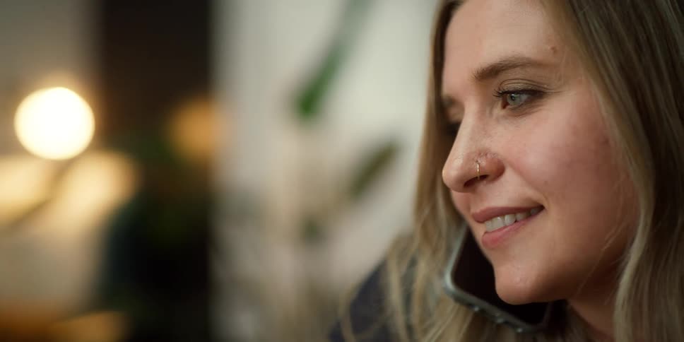 A woman can be seen talking on a smart phone