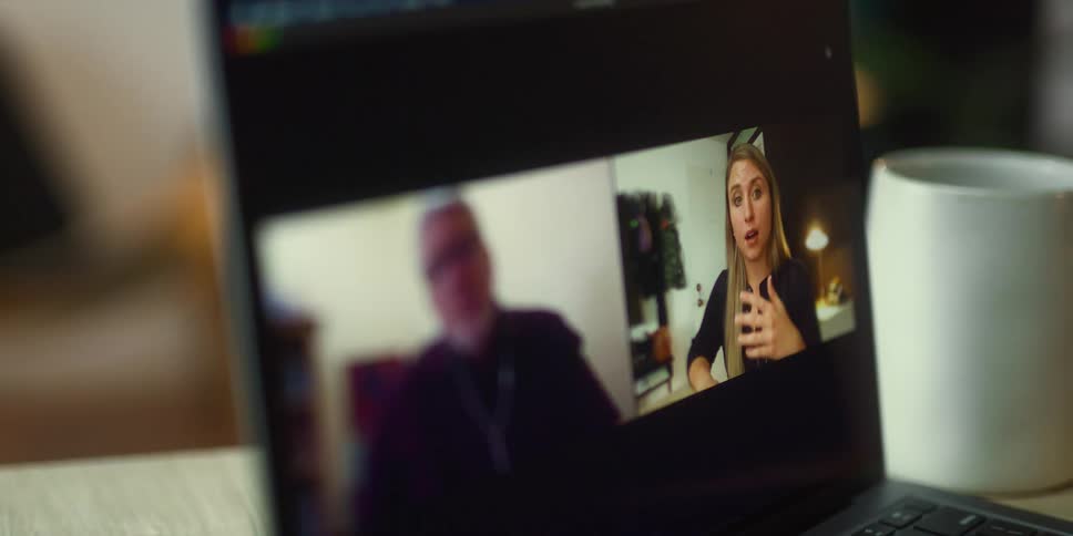 A woman using a video chat service on a laptop
