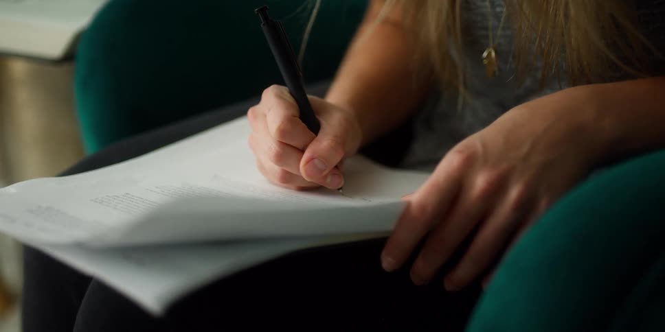 A woman writing on a paper