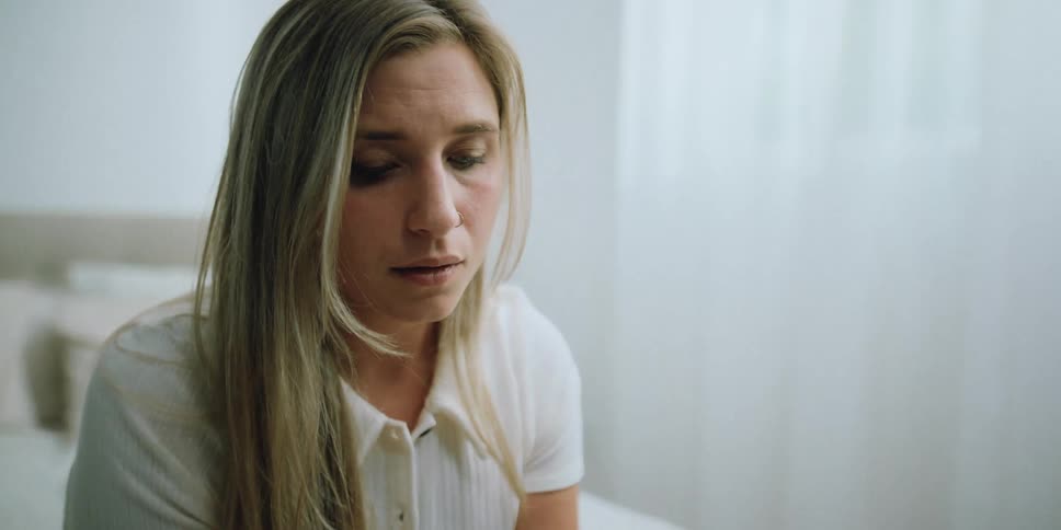 A woman looks sad as she reads a note