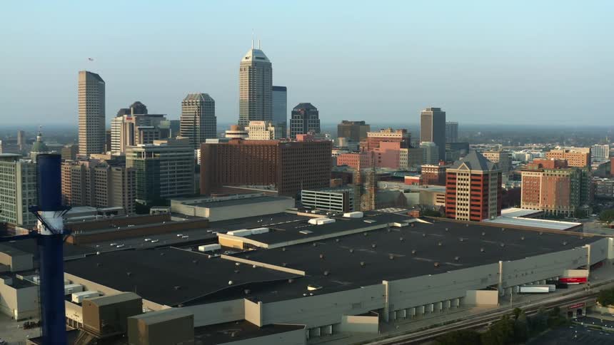 A city skyline with buildings and skyscrapers with the sky and clouds in the background