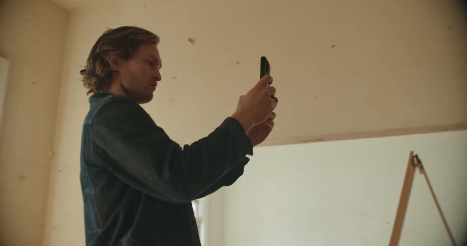 Man taking photos in house