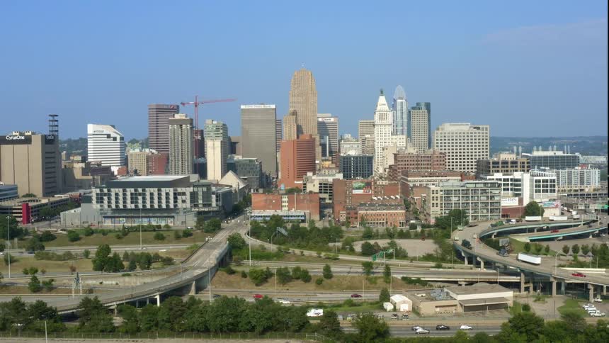 Aerial view of tall buildings and vehicles driving on highways