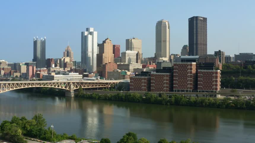 Aerial view of the skyscrapers on the skyline of the city downtown next to a river