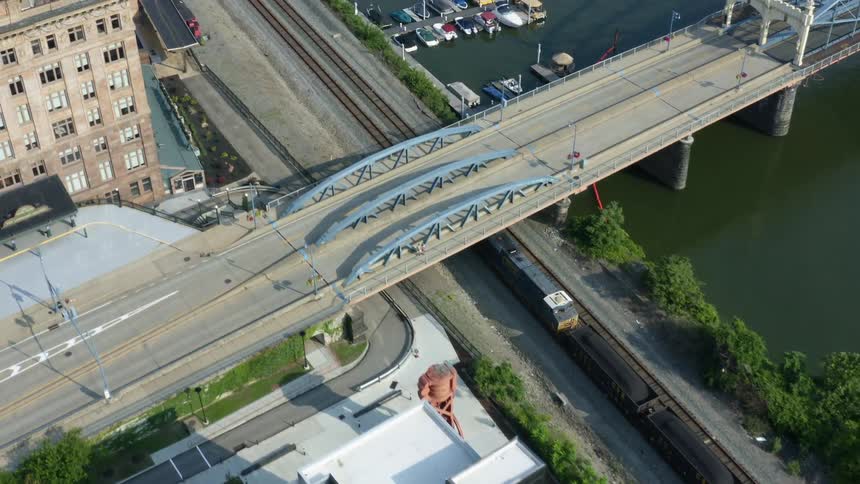 A train travels alongside a riverway
