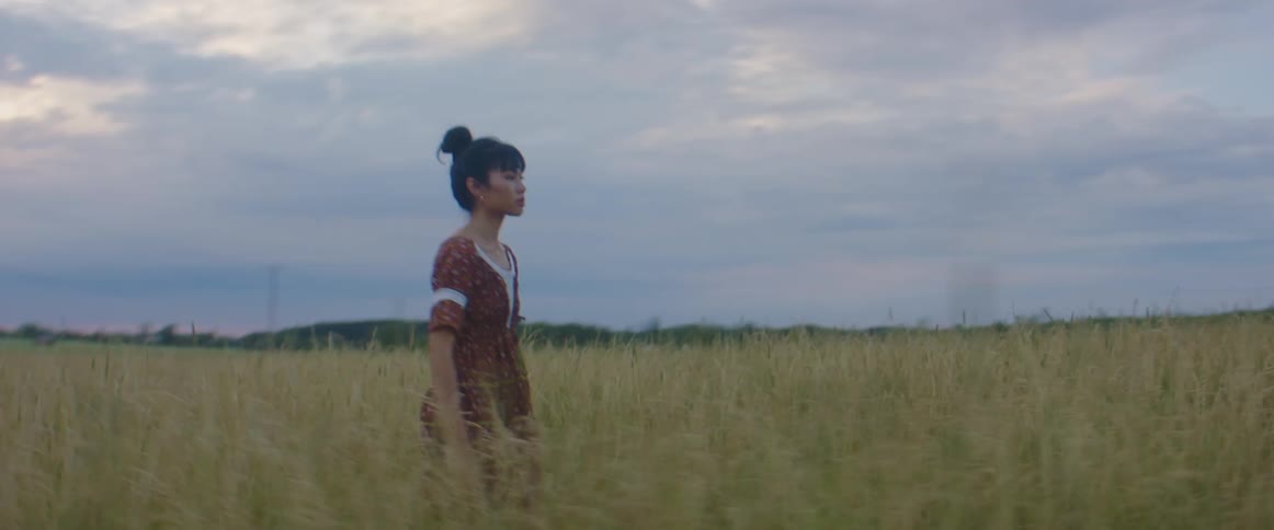 A woman walking in a wheat field
