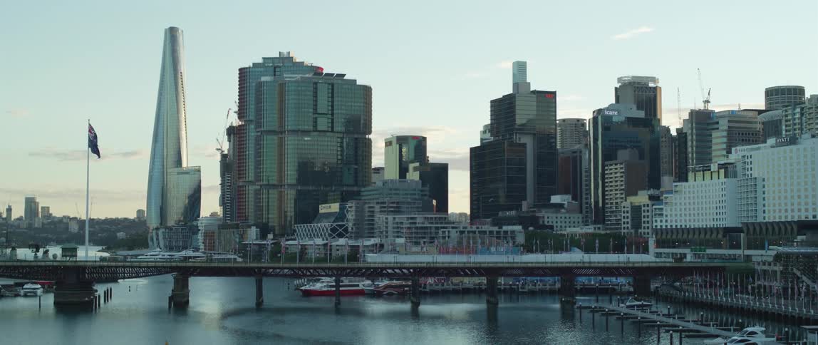 The sun is rising on the large city by the water
