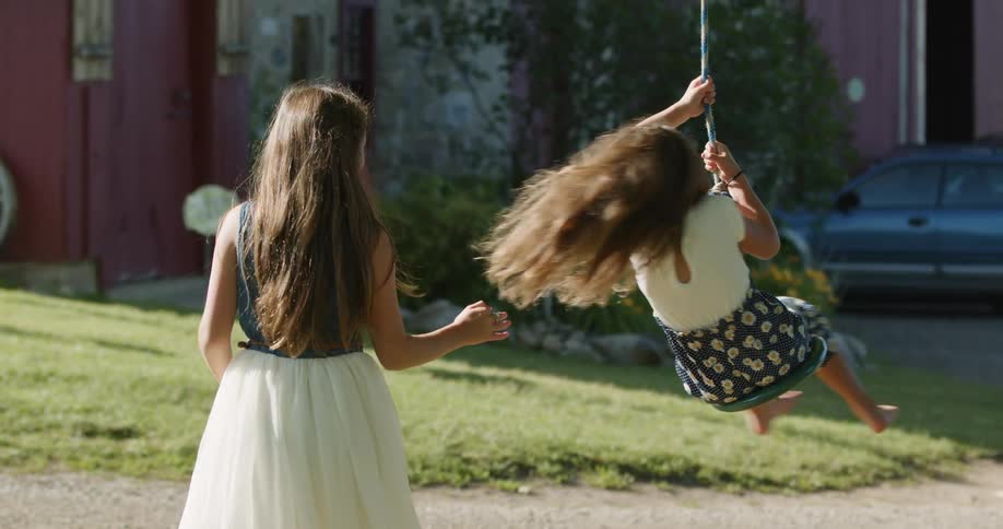 Two young girls playing outdoors