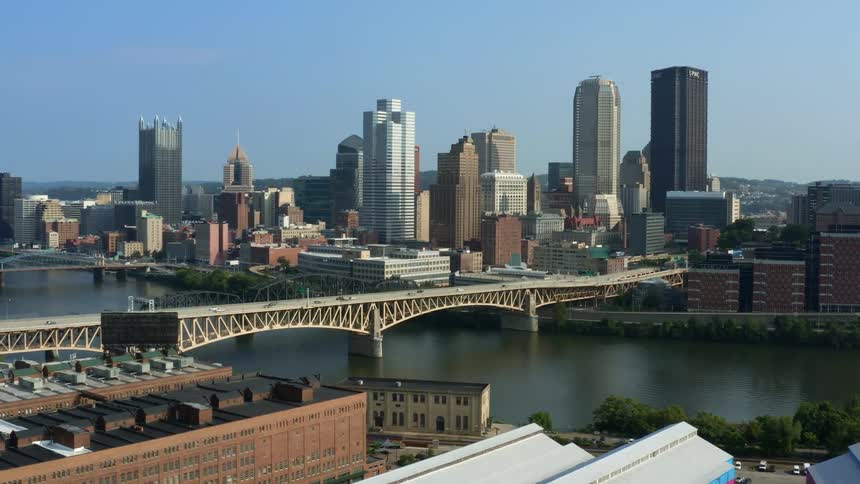 Aerial view of tall buildings and vehicles crossing the bridges