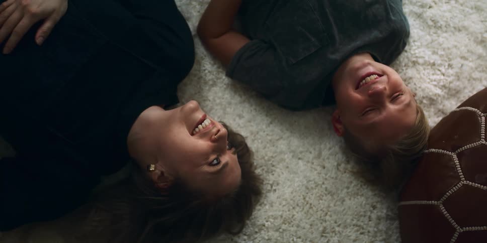 Mother and son resting over the white fluffy carpet on the floor at home