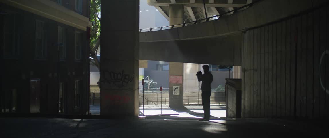 Photographer takes pictures of the underpass of a highway on a city