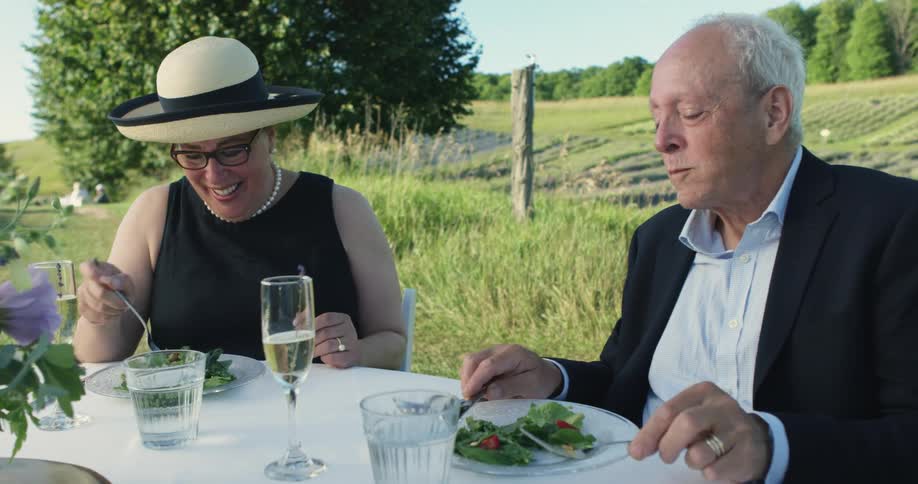 A man and woman eating food at a table